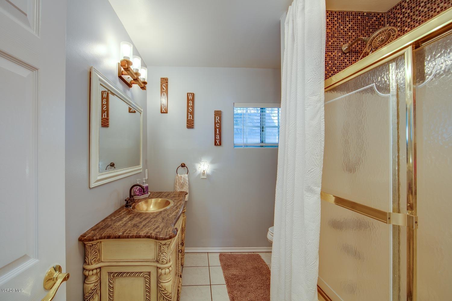 4265 Apricot Road Simi Valley, CA 93063 - Photo 28 of 39 a bathroom with a granite countertop sink and a mirror