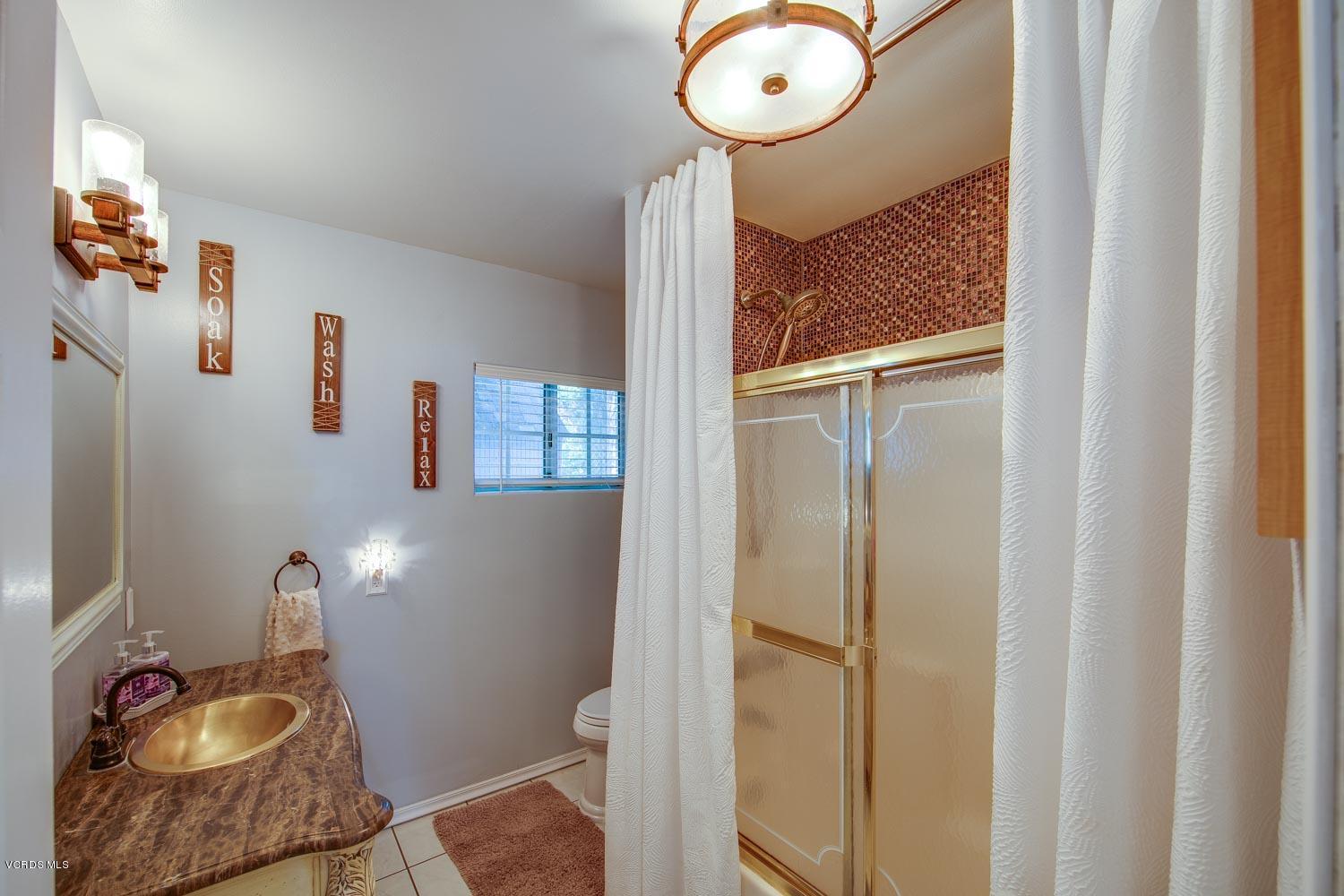 4265 Apricot Road Simi Valley, CA 93063 - Photo 29 of 39 a bathroom with a sink and a mirror