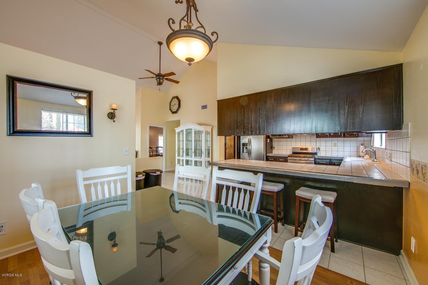 4265 Apricot Road Simi Valley, CA 93063 - Photo 9 of 39 a kitchen with stainless steel appliances granite countertop a sink a stove a dining table and chairs