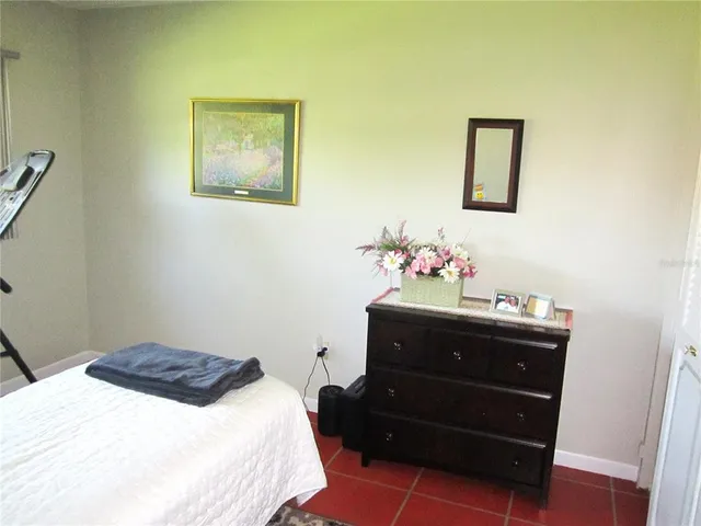 a bedroom with a bed and a dresser