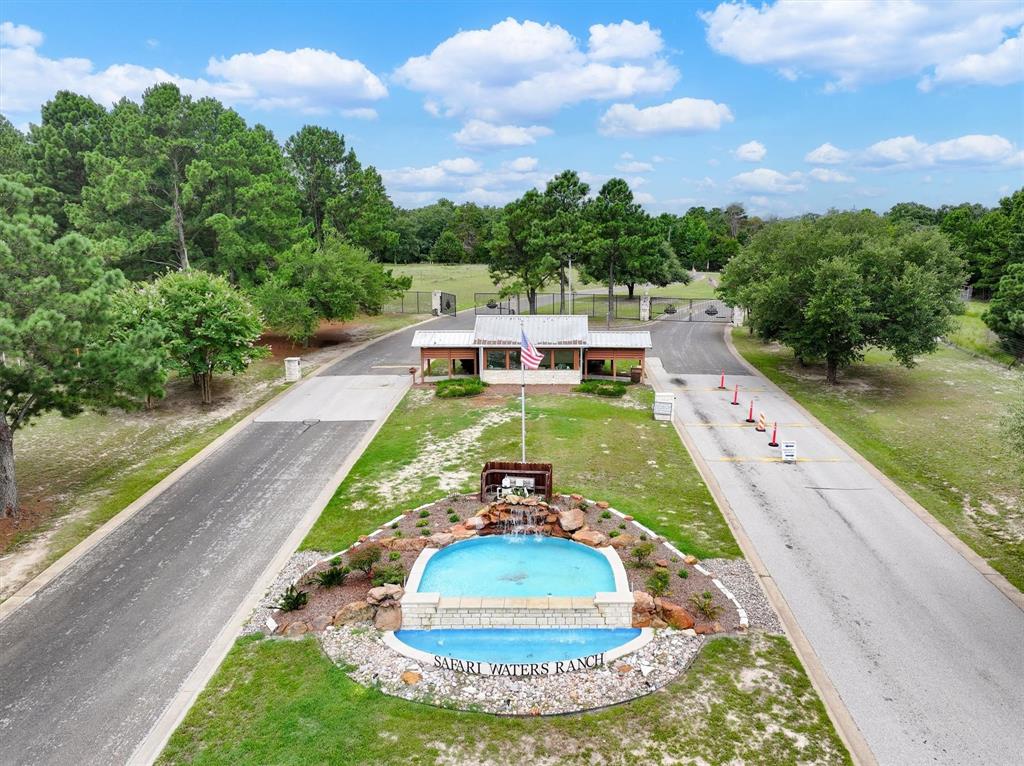 a view of a swimming pool with a yard and a fountain