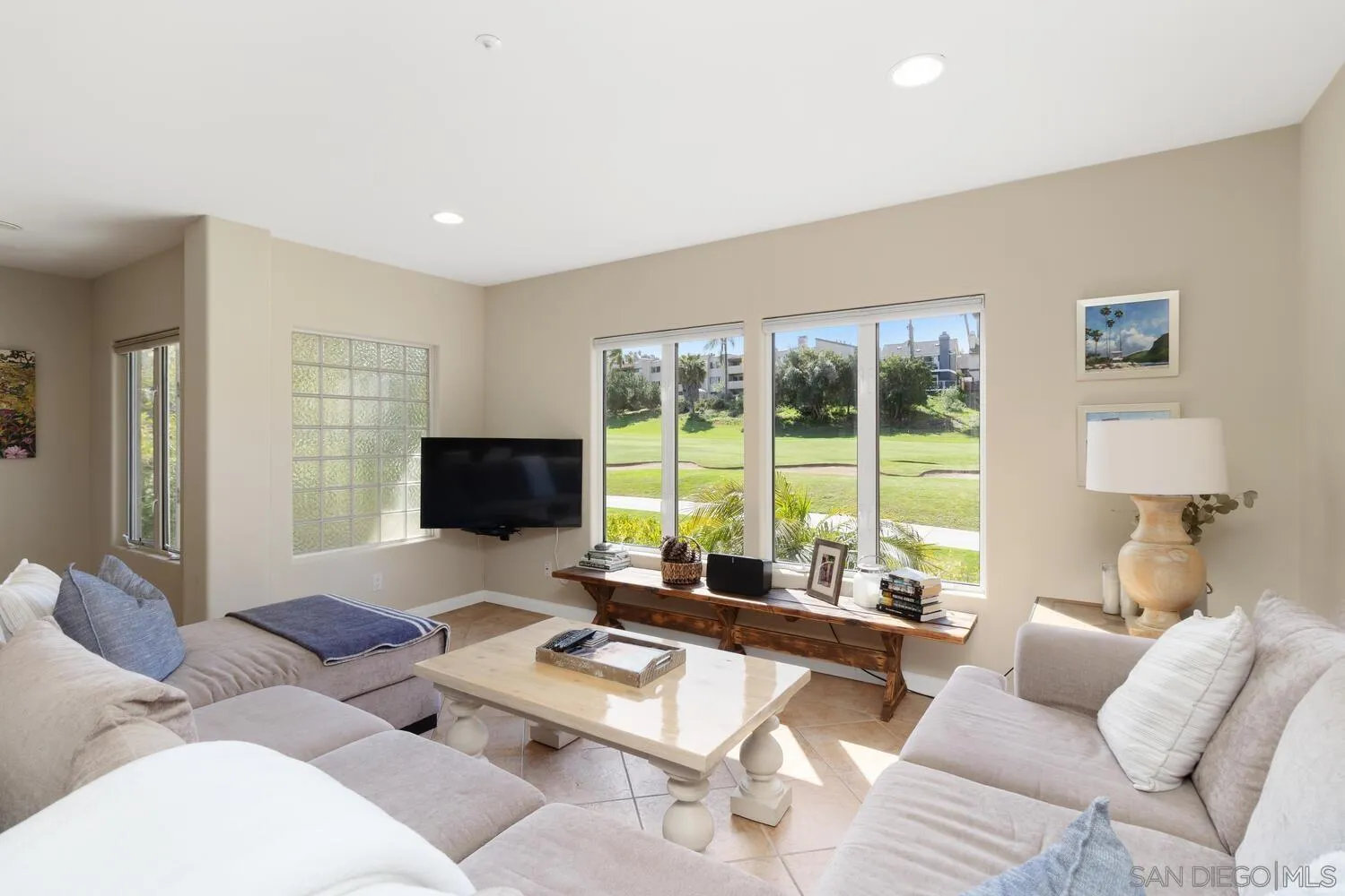7517 Jerez Court, Unit B Carlsbad, CA 92009 - Photo 1 of 26 a living room with furniture and a flat screen tv