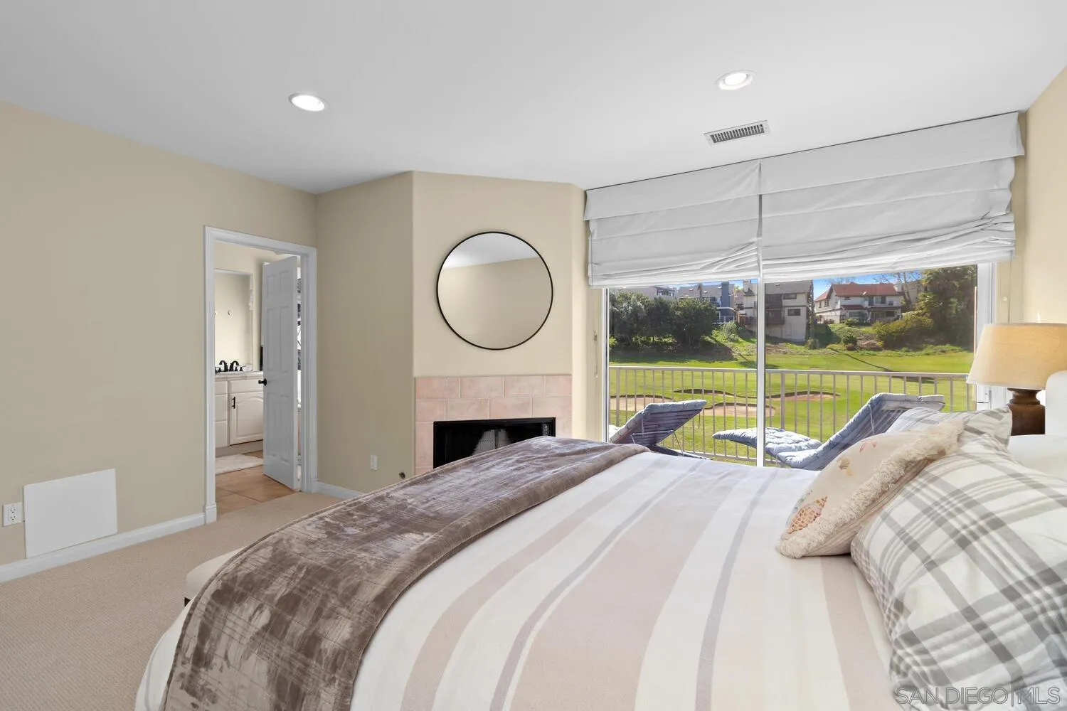 7517 Jerez Court, Unit B Carlsbad, CA 92009 - Photo 12 of 26 a bed sitting in a bedroom next to a window