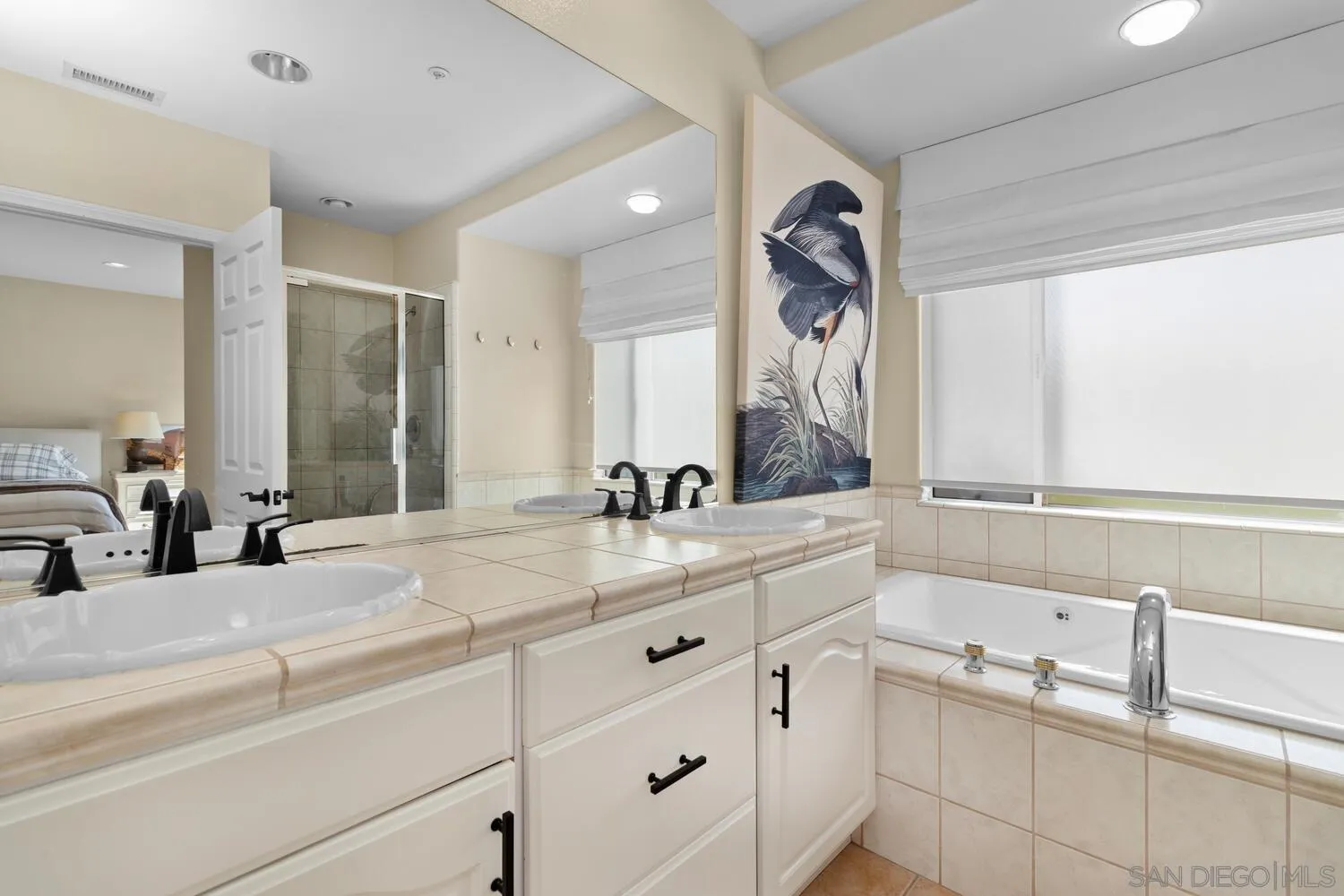 7517 Jerez Court, Unit B Carlsbad, CA 92009 - Photo 13 of 26 a bathroom with a sink double vanity and a mirror