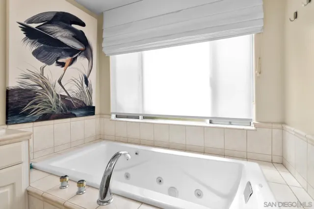 a bathroom with a bathtub and a window