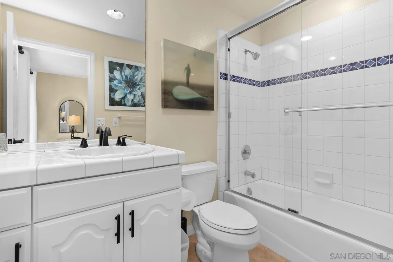 7517 Jerez Court, Unit B Carlsbad, CA 92009 - Photo 17 of 26 a bathroom with a sink a toilet and a mirror