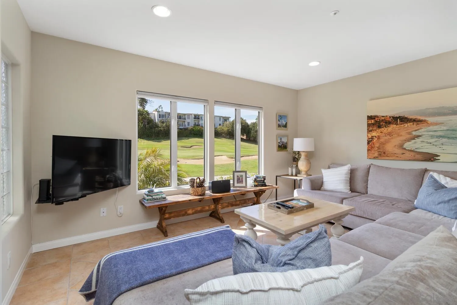 7517 Jerez Court, Unit B Carlsbad, CA 92009 - Photo 3 of 26 a living room with furniture large window and a flat screen tv