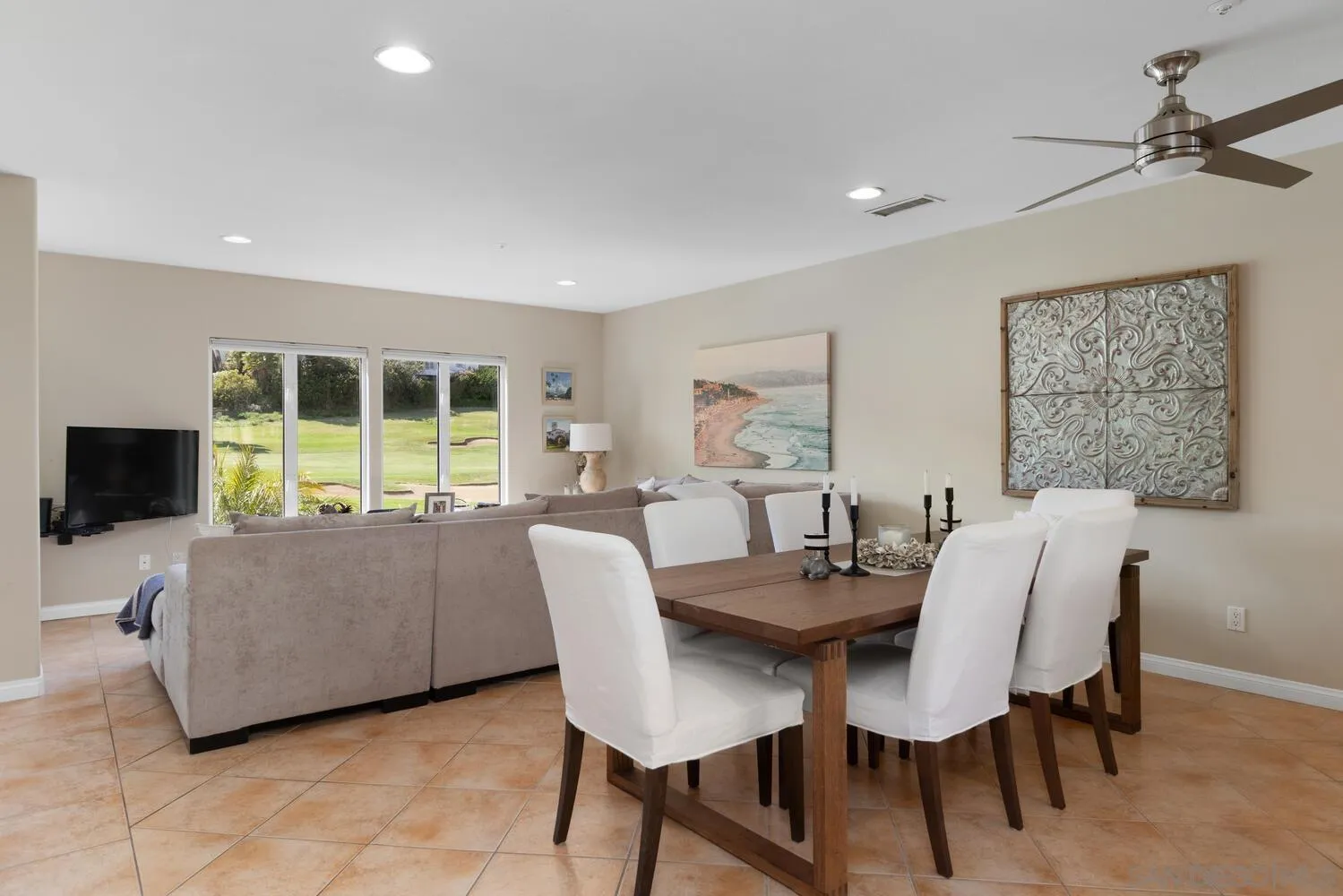 7517 Jerez Court, Unit B Carlsbad, CA 92009 - Photo 6 of 26 a view of a dining room with furniture and a flat screen tv