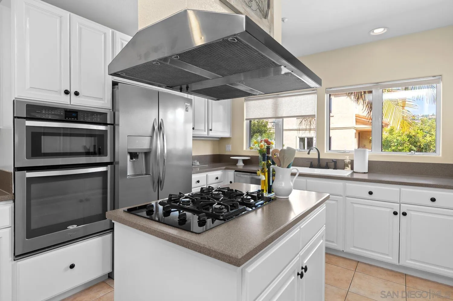 7517 Jerez Court, Unit B Carlsbad, CA 92009 - Photo 9 of 26 a kitchen with a stove a sink and a refrigerator