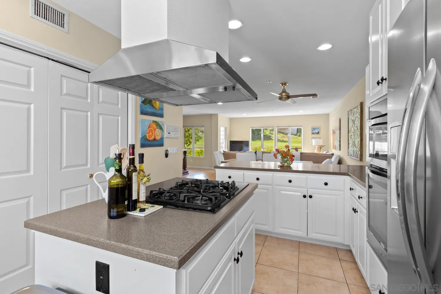 7517 Jerez Court, Unit B Carlsbad, CA 92009 - Photo 10 of 26 a kitchen with stainless steel appliances granite countertop a sink stove and refrigerator
