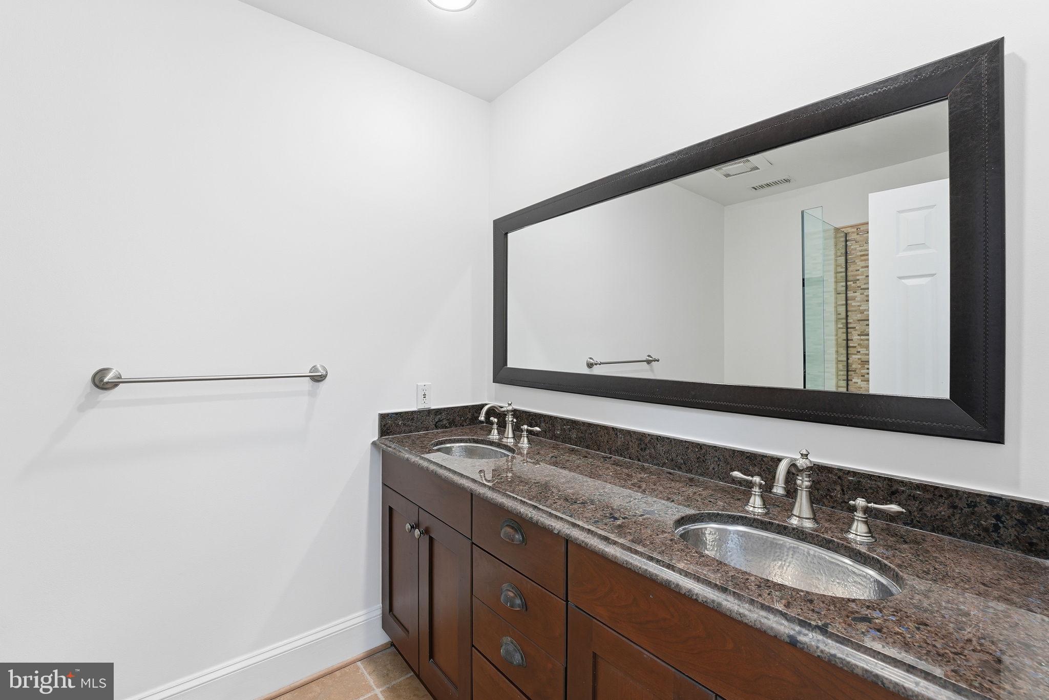 5149 MacArthur Boulevard Northwest Washington, DC 20016 - Photo 14 of 19 a bathroom with a granite countertop sink and a mirror