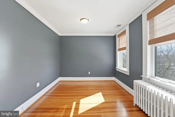 a view of a room with wooden floor and a window