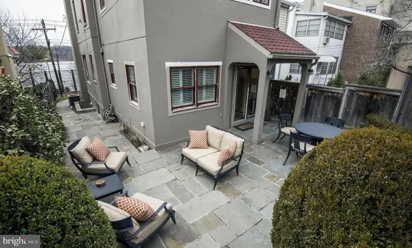 a view of a patio with chairs and a potted plant