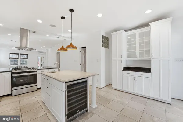a kitchen with white cabinets and appliances