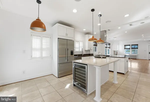 a kitchen with stainless steel appliances granite countertop a refrigerator a sink and a stove