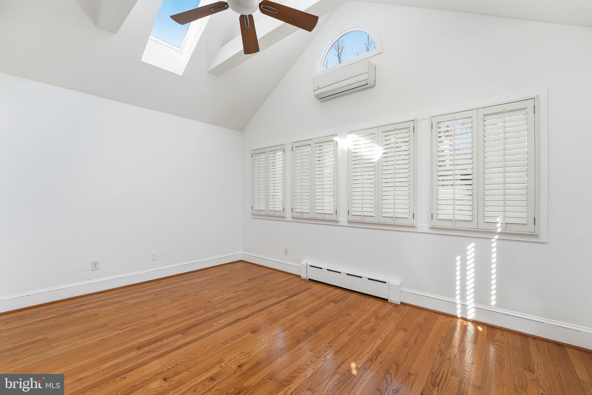 5149 MacArthur Boulevard Northwest Washington, DC 20016 - Photo 9 of 19 an empty room with wooden floor and windows