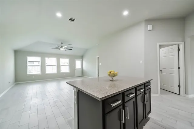 an empty room with wooden floor and window