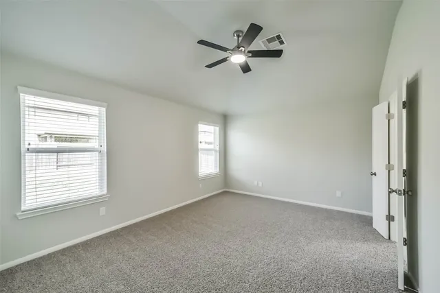 a view of a livingroom with a ceiling fan and window