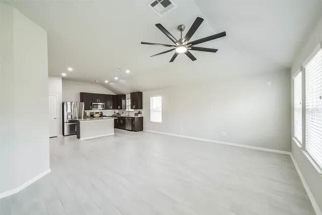 a view of a kitchen with a sink and a window