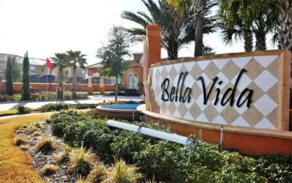 a view of a sign in a yard with potted plants