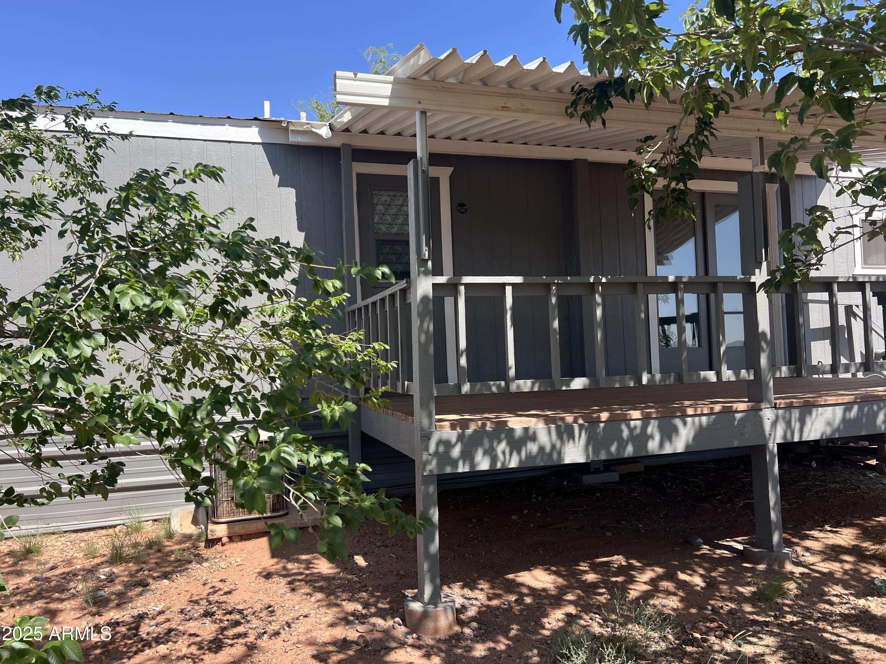 9864 Uttecht Trail Snowflake, AZ 85937 - Photo 2 of 12 a view of a house with large windows and a tree
