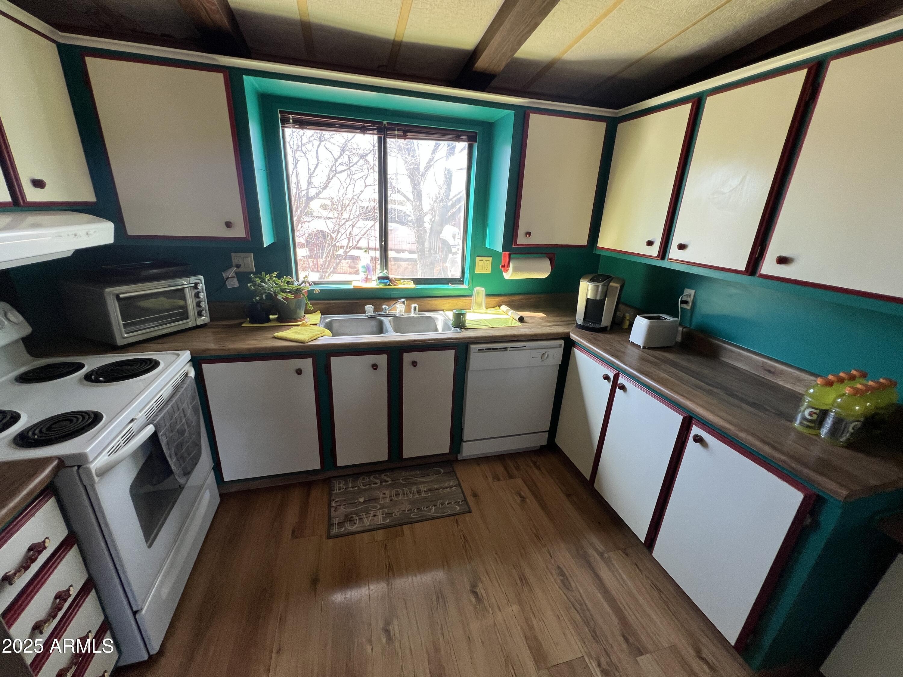 9864 Uttecht Trail Snowflake, AZ 85937 - Photo 8 of 12 a kitchen with stainless steel appliances a stove a sink and a microwave