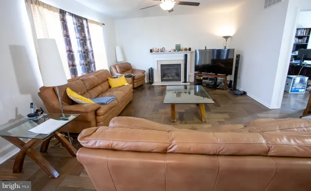 a living room with furniture and a potted plant