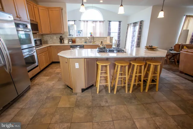a living room with furniture and a book shelf