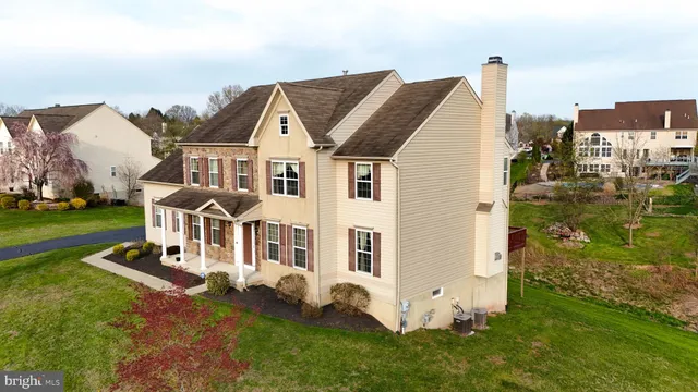 a view of a house with a yard and sitting area