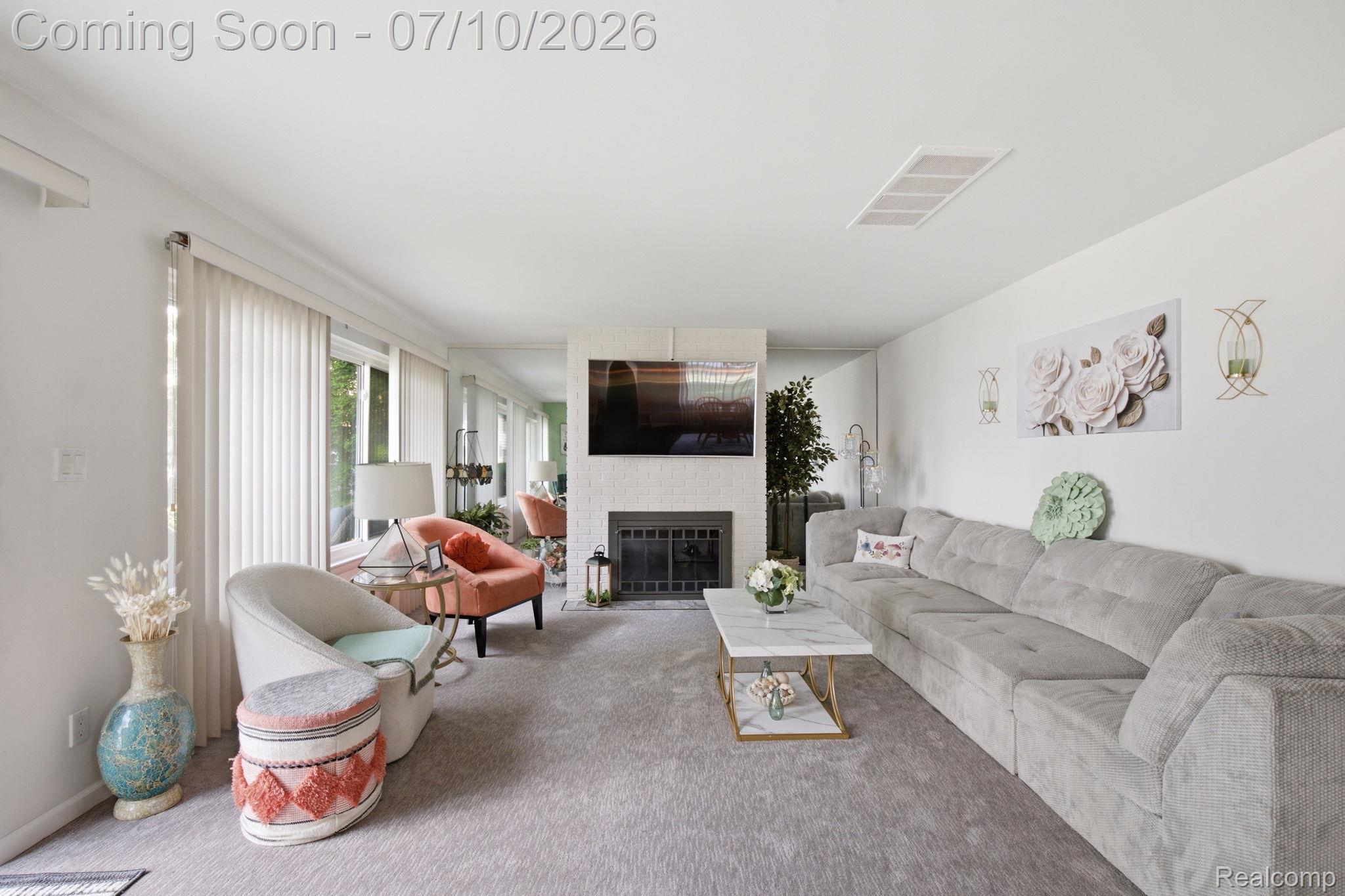 1501 River Road, Unit 301 St. Clair, MI 48079 - Photo 14 of 32 Spacious living area featuring light gray carpeting, a white stone-clad fireplace, and an integrated media wall