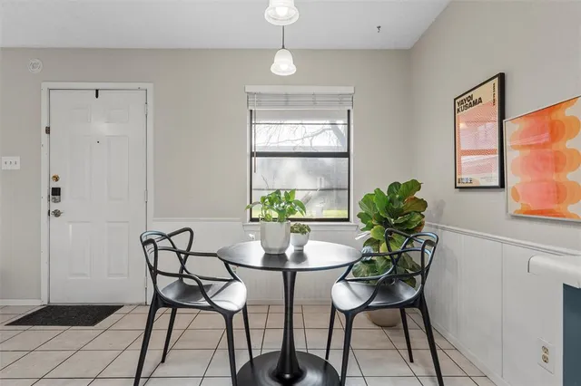 a kitchen with stainless steel appliances a dining table chairs and granite counter tops