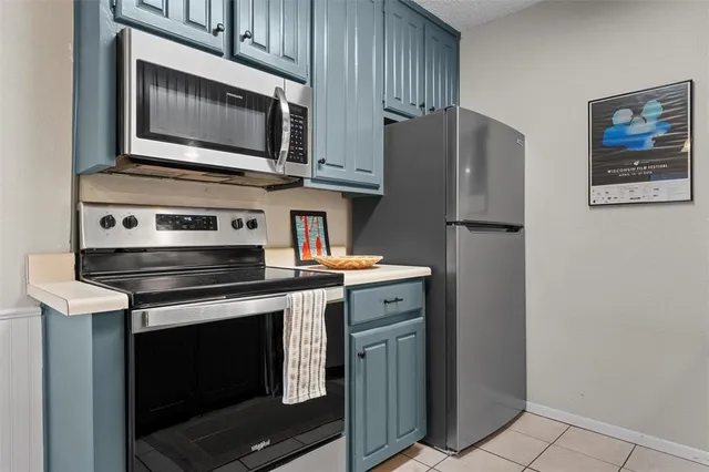 a kitchen with a sink cabinets and stainless steel appliances