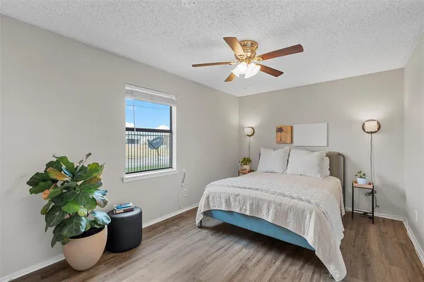 a bedroom with a bed and a night stand