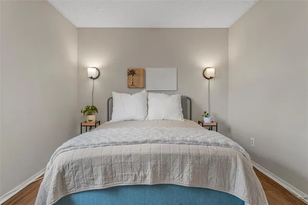 a bedroom with a bed and a chandelier