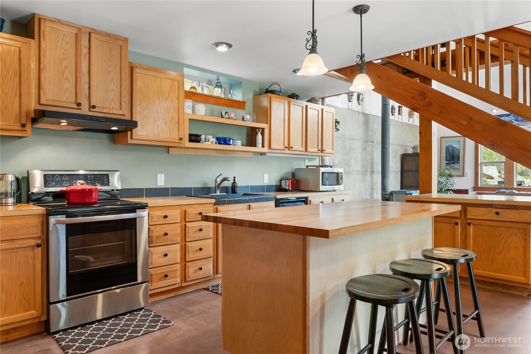 96 Alder Creek Road Twisp, WA 98856 - Photo 10 of 40 a kitchen with stainless steel appliances granite countertop a stove and white cabinets