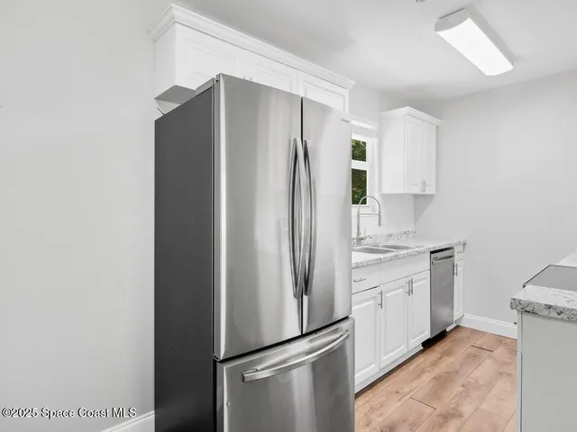 a kitchen with stainless steel appliances a refrigerator and a sink