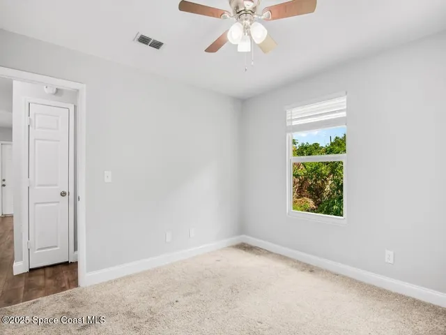 an empty room with windows and closet