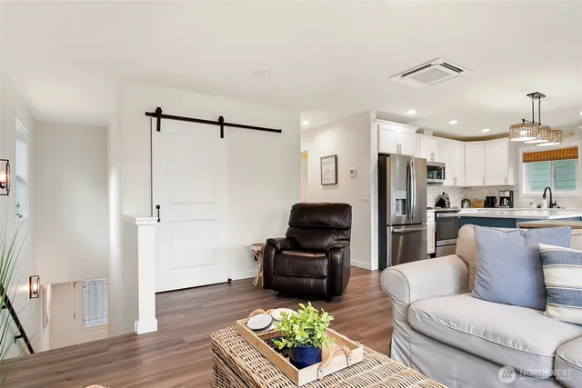 a living room with furniture and kitchen view