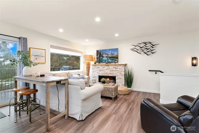 a living room with furniture a fireplace and a table