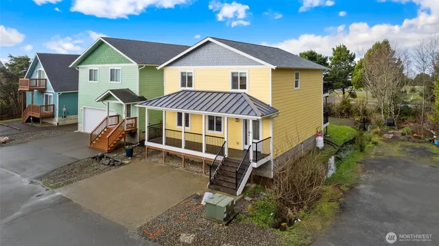 a view of a house with a yard and wooden fence