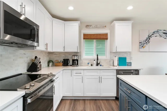 a kitchen with a sink a stove and cabinets