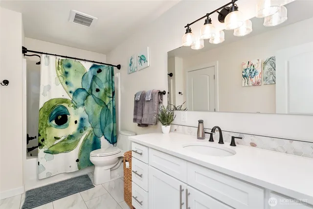 a bathroom with a sink mirror and toilet