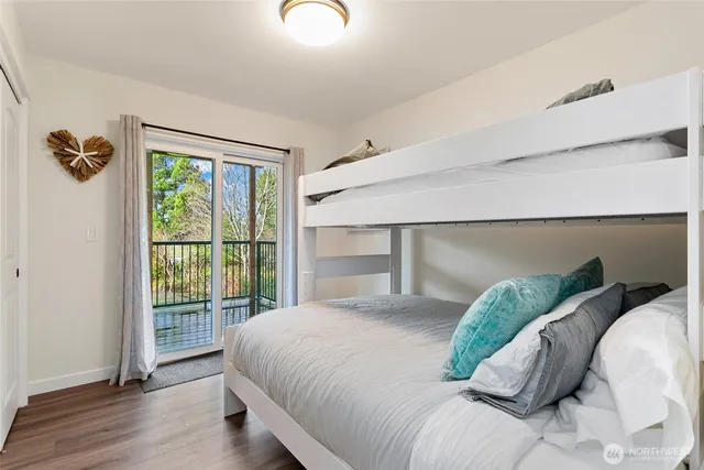 a bedroom with a bed a window and potted plant