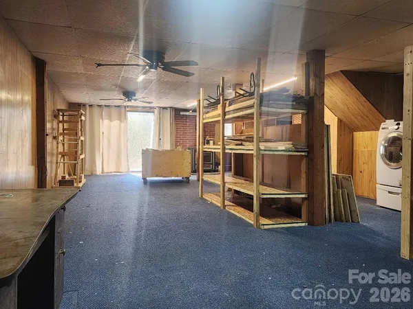 a view of a livingroom with furniture and staircase
