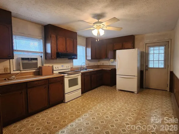 a kitchen with a refrigerator sink and cabinets