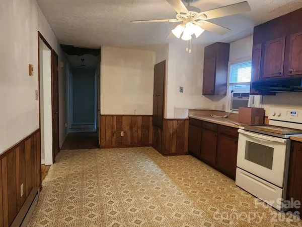 a kitchen with stainless steel appliances a stove a sink and a refrigerator