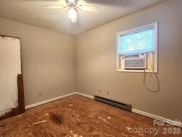 a view of a room with wooden floor and windows