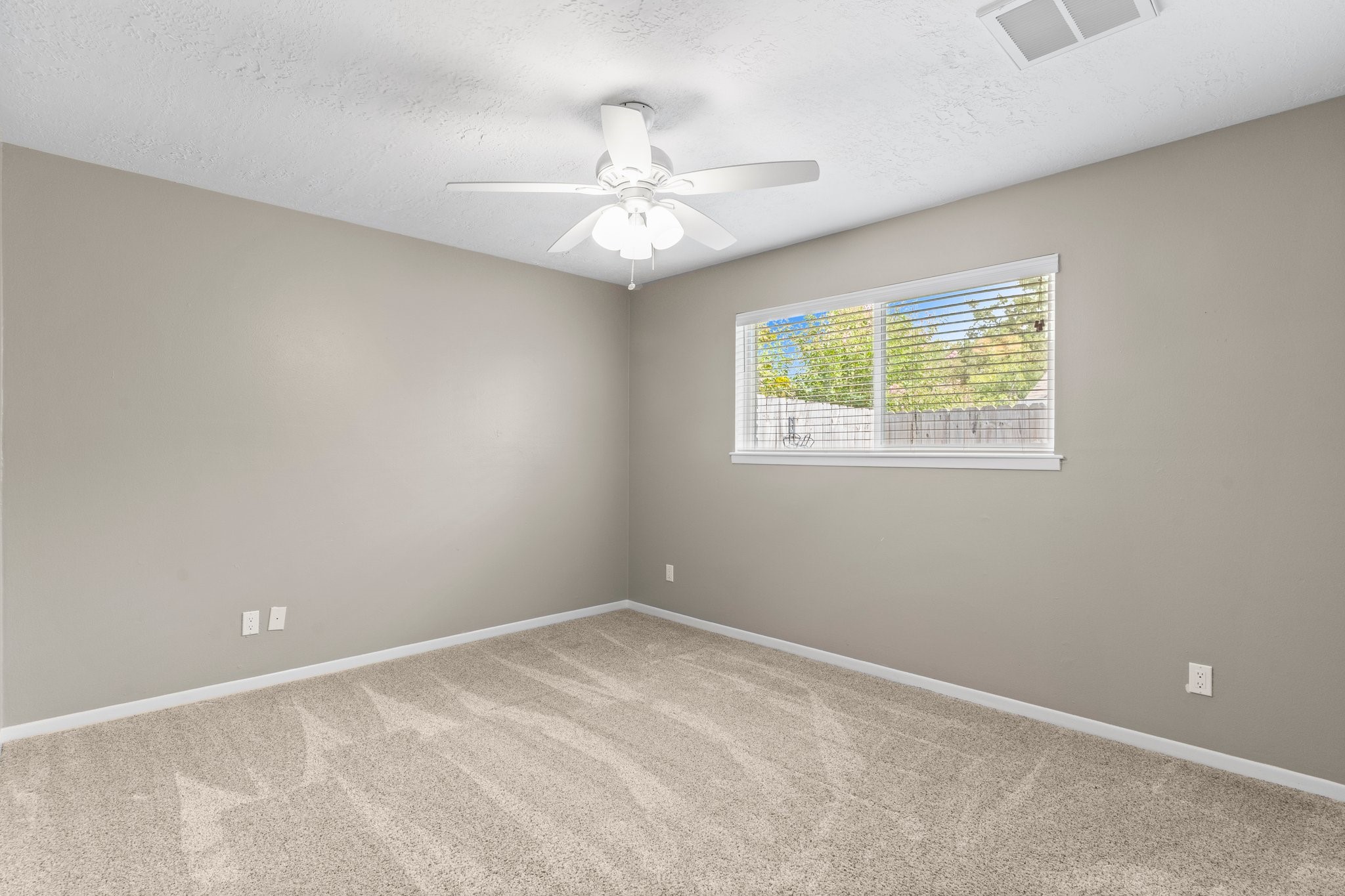 27234 Wells Lane Conroe, TX 77385 - Photo 7 of 15 an empty room with windows and fan