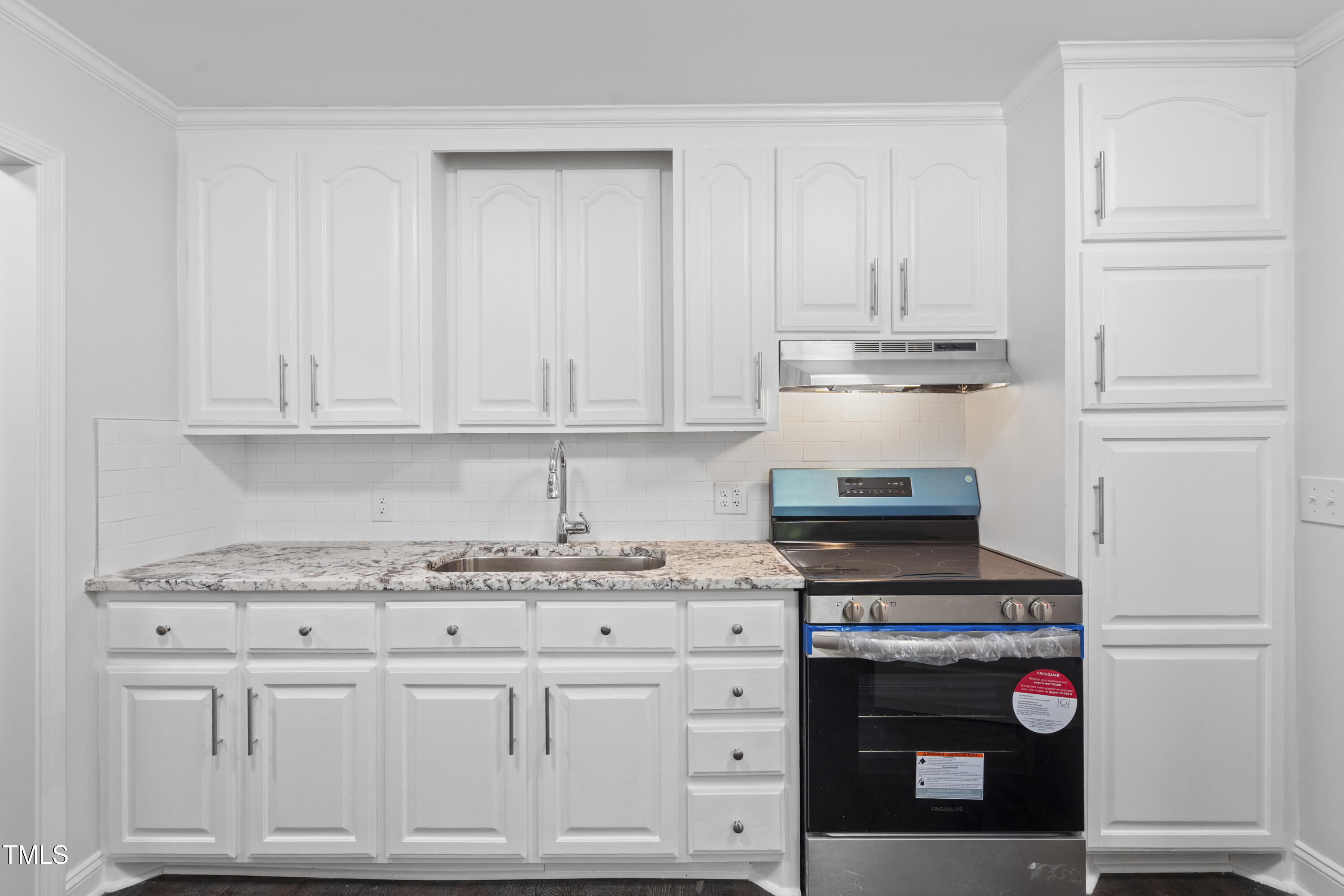 951 Walter Bright Road Sanford, NC 27330 - Photo 11 of 42 a kitchen with stainless steel appliances granite countertop a stove and white cabinets