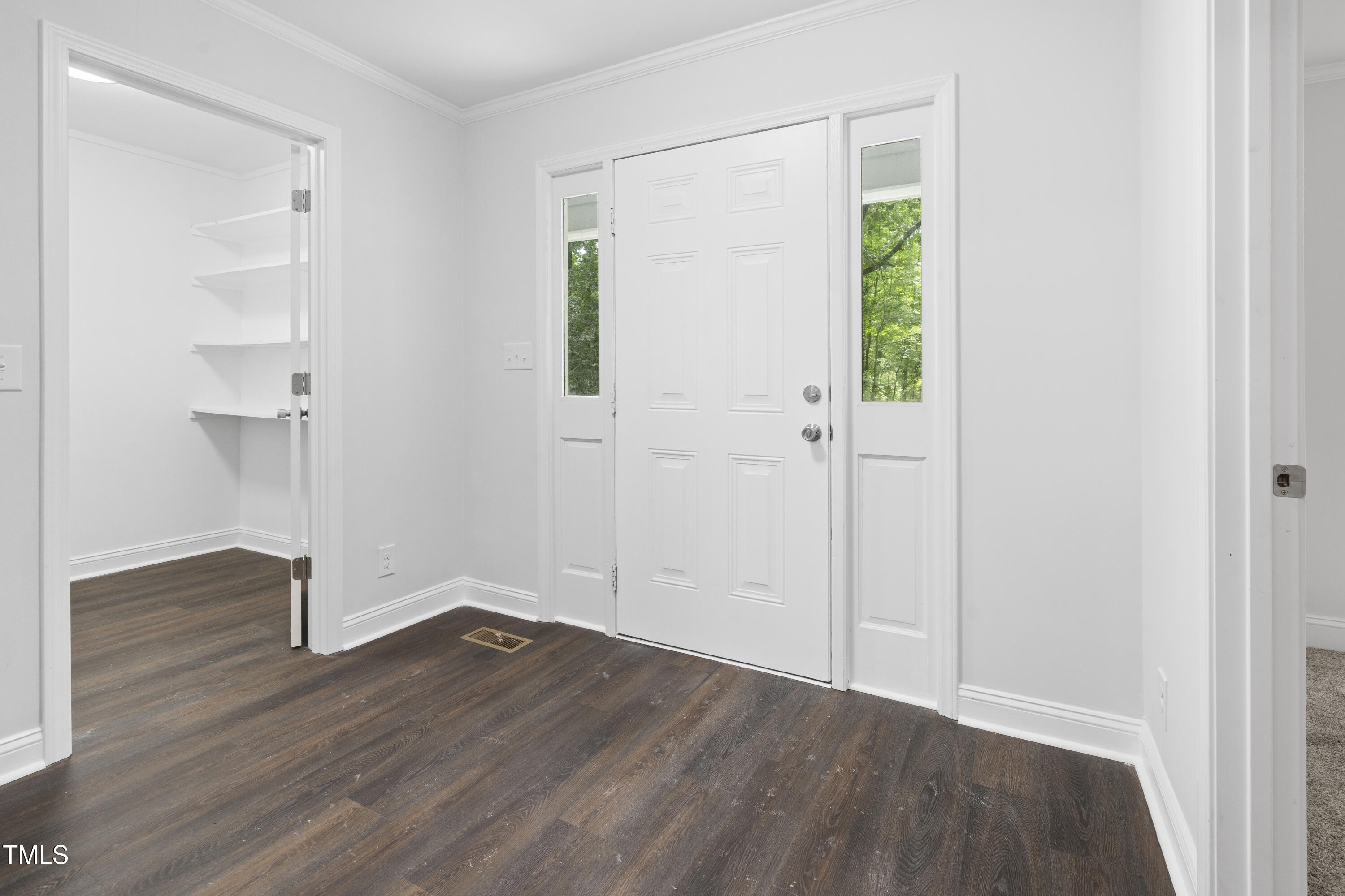 951 Walter Bright Road Sanford, NC 27330 - Photo 13 of 42 an empty room with wooden floor and windows